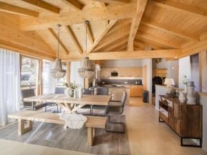 a kitchen and dining room with a wooden ceiling at Chalet in Königsleiten near Ski Lift in Wald im Pinzgau