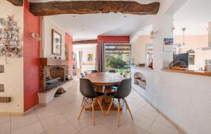 a kitchen and dining room with a wooden table and chairs at Pet Friendly Home In Montauroux in Montauroux