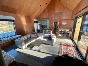 a living room with a couch and a table at Cedarwood Retreat - Castle Hill Holiday Home in Castle Hill