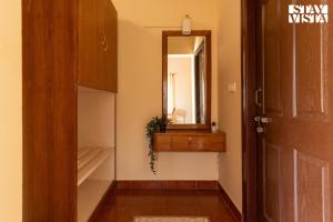 a dressing room with a mirror and a closet at Three Rivers by VEO - Part of StayVista in Jambur +24 photos