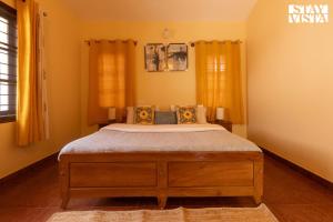 a bedroom with a large bed in a room at Three Rivers by VEO - Part of StayVista in Jambur