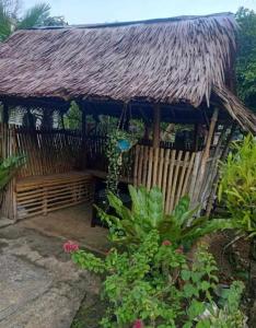 a bamboo hut with a thatched roof at Anda homestay in Anda