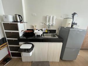 a small kitchen with a sink and a refrigerator at Aras Solace Place in Trece Martires