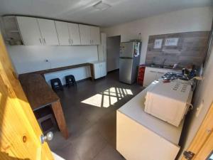 an overhead view of a kitchen with a counter and refrigerator at Aero Hostal in Santiago