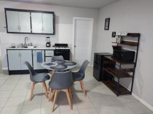 a kitchen with a table and chairs in a room at Departamento en Campo 3A in Campo 3 "B"