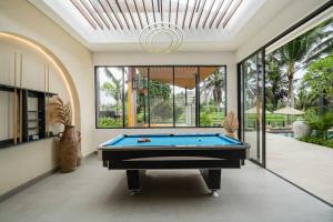 a pool table in a living room with a ceiling at Villa Pacifida by BaliSuperHost in Ubud +43 photos