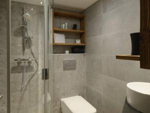 a bathroom with a shower and a toilet and a sink at Courchevel 1850: Duplex charmant 6 pers près centre, parking, wifi - FR-1-631-228 in Courchevel