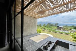 a view from the window of a room with a tub at Batur Sunsun Kintamani in Kubupenlokan