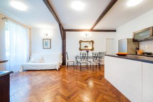 a living room with a kitchen and a dining room at Apartment Heart of the City in Šibenik