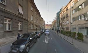 a street with cars parked on the side of the road at Apartments Zagreb Point - Vinogradska in Zagreb