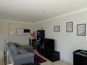 a living room with a couch and a tv at Casa Das Faias in Santa Cruz da Graciosa