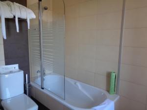 a bathroom with a tub and a toilet and a shower at Casa Das Faias in Santa Cruz da Graciosa +20 photos