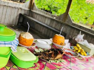 a table with some food and drinks on it at Korbekwan Homestay in Besir +41 photos