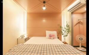 a bedroom with a bed with a stuffed animal on it at Handmade Hotel Zena in Daegu