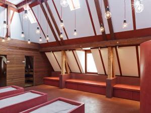 A bed or beds in a room at Alma Hotel