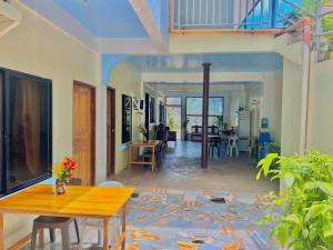 a living room with a table and a dining room at Carillo guest house in Coron