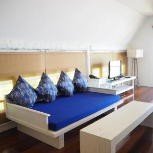 a large bed with blue pillows in a room at The Blue Sky Resort @ Ranong in Ranong