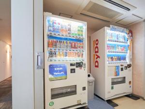 two vending machines in a room with drinks at Richmond Hotel Aomori in Aomori
