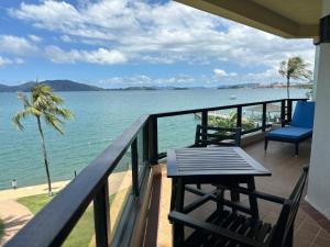a balcony with a table and chairs and the ocean at Shangri-La Tanjung Aru, Kota Kinabalu in Kota Kinabalu