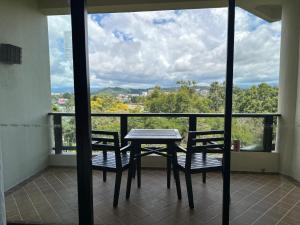 a table and two chairs on a balcony with a view at Shangri-La Tanjung Aru, Kota Kinabalu in Kota Kinabalu