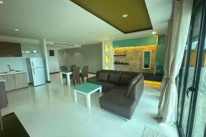 a living room with a couch and a table at Kamala Villa Hill in Kamala Beach
