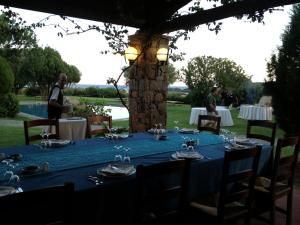 a table set up for a dinner party with a blue table cloth at Hotel Spartivento in Chia
