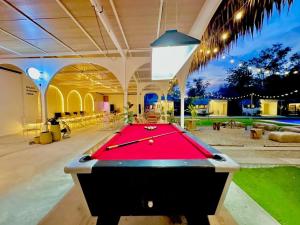 a pool table in the middle of a room with a pool table at Beach House Pool Villa in Na Jomtien