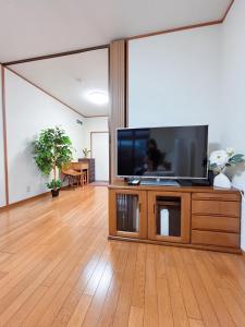 a living room with a large flat screen tv at 桜の宿-大阪城Osaka castle-105m2 private-5Way access-KIX USJ 難波心斎橋 Direct in Osaka