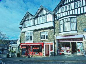 a large building with a store in front of it at Monties Guest House - Adults ONLY in Bowness-on-Windermere