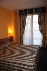 Postel nebo postele na pokoji v ubytování Hotel Tre Denti + 37 fotografií