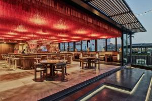 a restaurant with tables and chairs on a roof at Wyndham Grand Istanbul Kalamış Marina Hotel in Istanbul