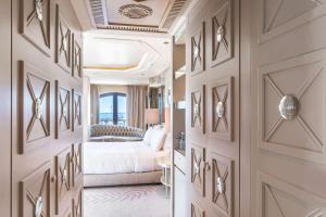 a hotel room with a bed and a hallway at Wyndham Grand Istanbul Kalamış Marina Hotel in Istanbul