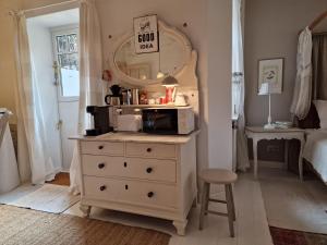 a bedroom with a dresser with a microwave on it at Kleine Auszeit in Detmold