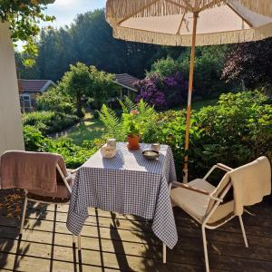 a table and chairs under an umbrella on a patio at Kleine Auszeit in Detmold +84 photos