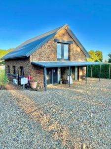a large brick house with a blue roof at Elevation652 at Mt Bellevue in King Valley in Myrrhee