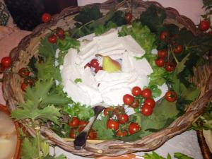 a plate of lettuce and tomatoes on a table at Hotel Spartivento in Chia