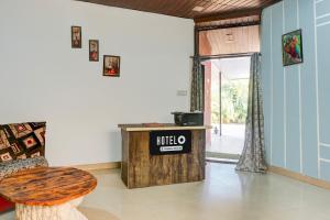 um quarto com uma mesa e um banco num quarto em Hotel O Malavli Lonavala Hill View em Lonavala