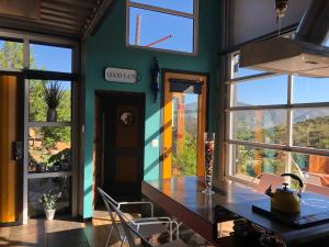 a dining room with a table and some windows at Chalet Contenedor con Hot Tub exterior exclusivo in Las Palmas