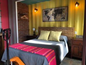 a bedroom with a bed with a pink blanket on it at Chalet Contenedor con Hot Tub exterior exclusivo in Las Palmas +21 photos