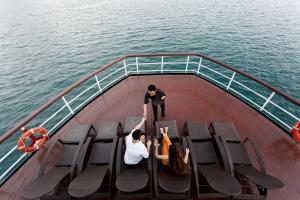 a group of people on a boat in the water at Emeraude Classic Cruises in Ha Long