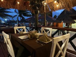a table at a restaurant on the beach at The Diving Lodge Downtown in Puerto Morelos