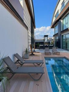 a house with a swimming pool next to a house at Royal Garden 7 Villas in Dosemealti