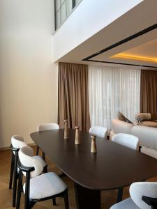 a room with a table and chairs and a couch at Royal Garden 7 Villas in Dosemealti +143 photos