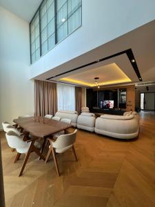 a living room with a wooden table and white furniture at Royal Garden 7 Villas in Dosemealti +143 photos