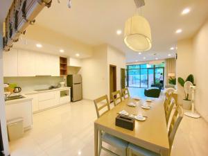 a kitchen and dining room with a table and chairs at New Life Bai Chay Condotel in Ha Long