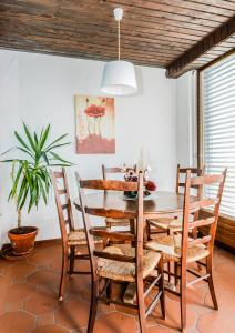 a dining room with a wooden table and chairs at Collina d'Oro Orselina Locarno in Locarno