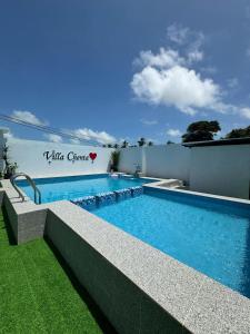 a swimming pool in the backyard of a house at VILLA CHENTA BACHOk KELANTAN in Bachok
