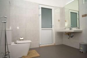 a bathroom with a toilet and a sink at Liora Homestay in Gelioya +154 photos
