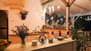a kitchen with a table with fruits and flowers on it at LaWanda9 in Vama Veche