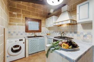 a kitchen with a bowl of vegetables on a counter at Masseria Pitorre With Pool - Happy Rentals in Conversano